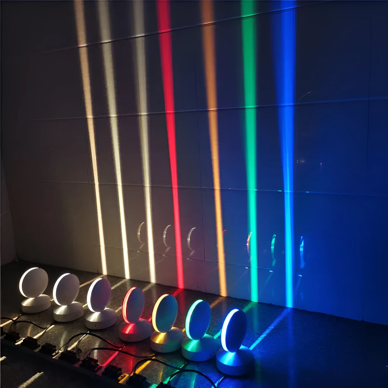 Modern aluminium spotlight bar wall lamp with glass lens, mounted on a wall.