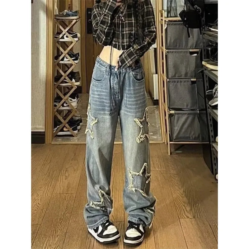 Blue women's high waist wide-leg denim jeans on a hanger, showing the straight leg cut.