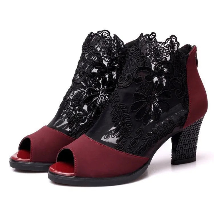Black women's gladiator sandals with flower lace upper, square heel, and back zip closure.