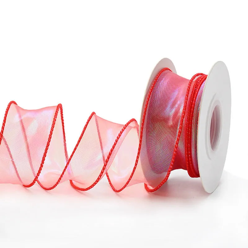 Roll of 4cm wide colourful mesh ribbon with fishtail yarn floral wave design.