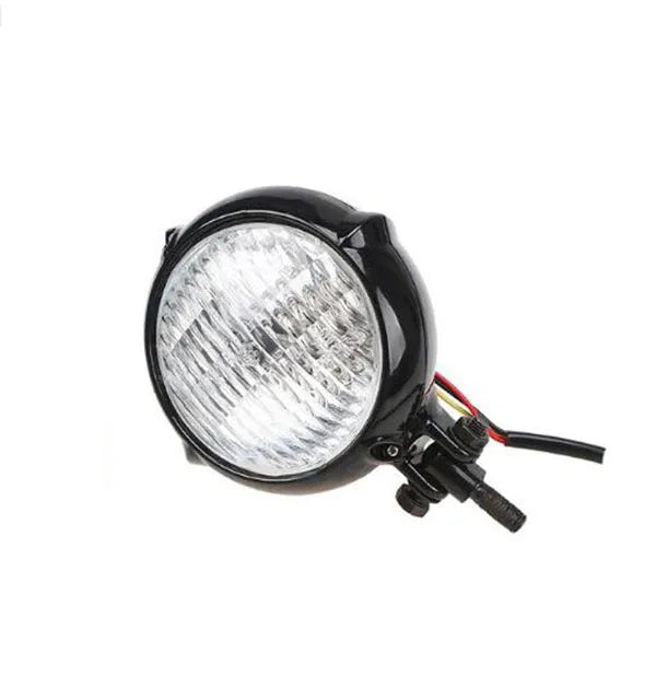 Black retro Harley-style halogen headlight for cars with yellow glass lens.
