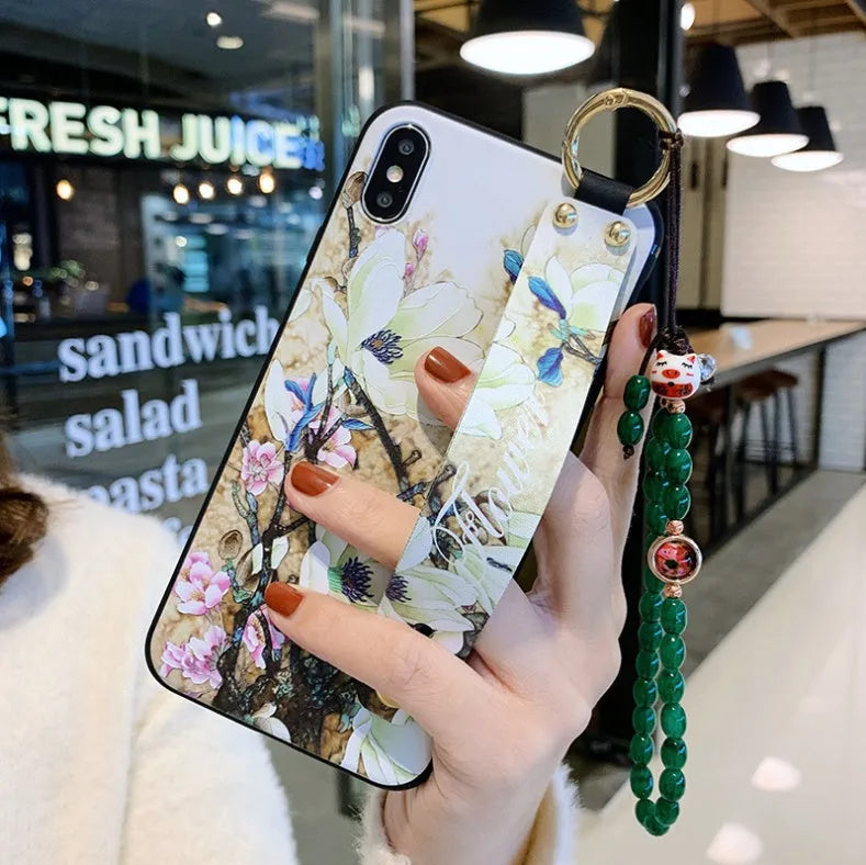 Samsung Galaxy phone case with folding bracket extended, showing floral pattern design
