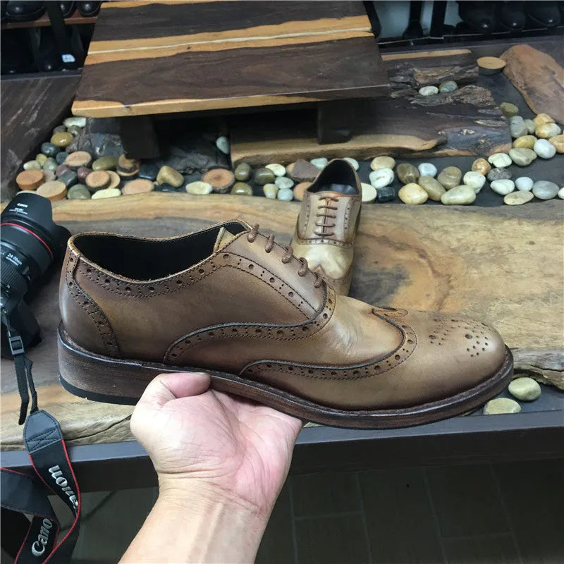 Men's light brown vintage distressed leather shoes with engraved detailing and round toe.
