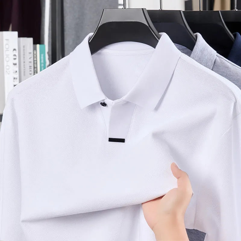 Man modelling a grey loose-fit cotton polo shirt with a lapel collar and asymmetric design.