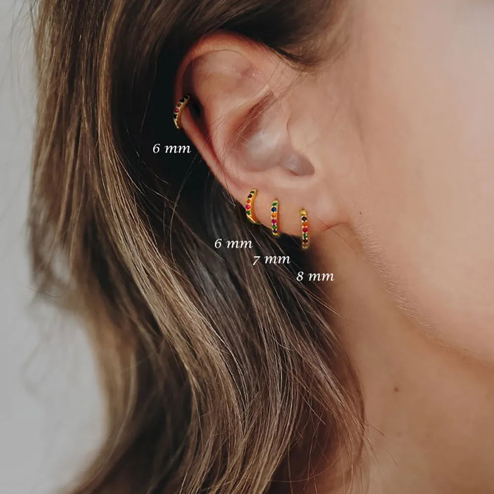 Gold, rose gold, and silver coloured perforated circle zircon stud earrings in various sizes from 5mm to 12mm.