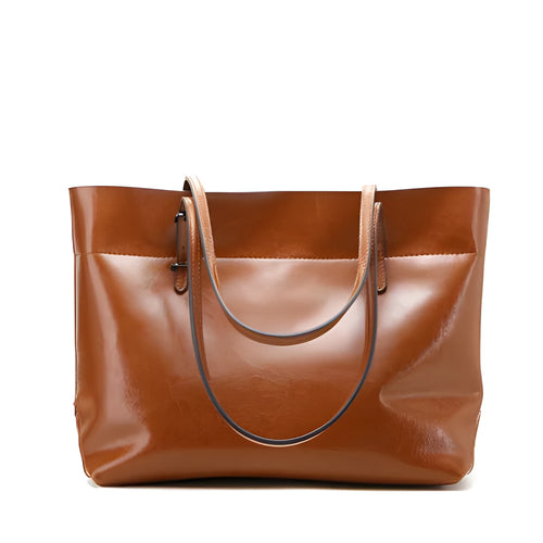 Brown waxed cowhide cross-body handbag showing front flap and adjustable shoulder strap.