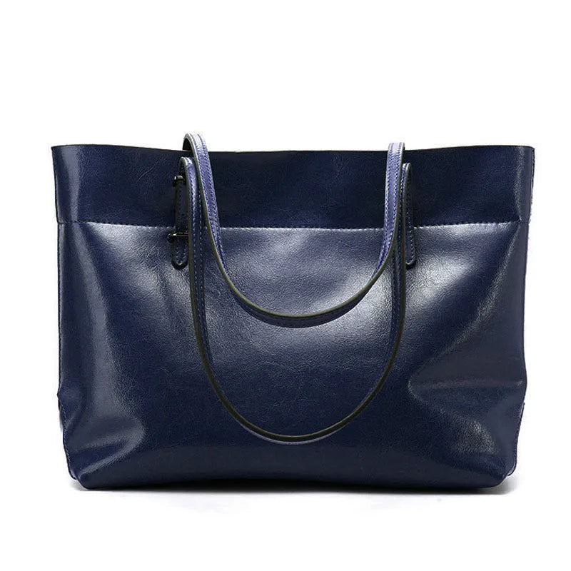 Brown waxed cowhide cross-body handbag showing front flap and adjustable shoulder strap.
