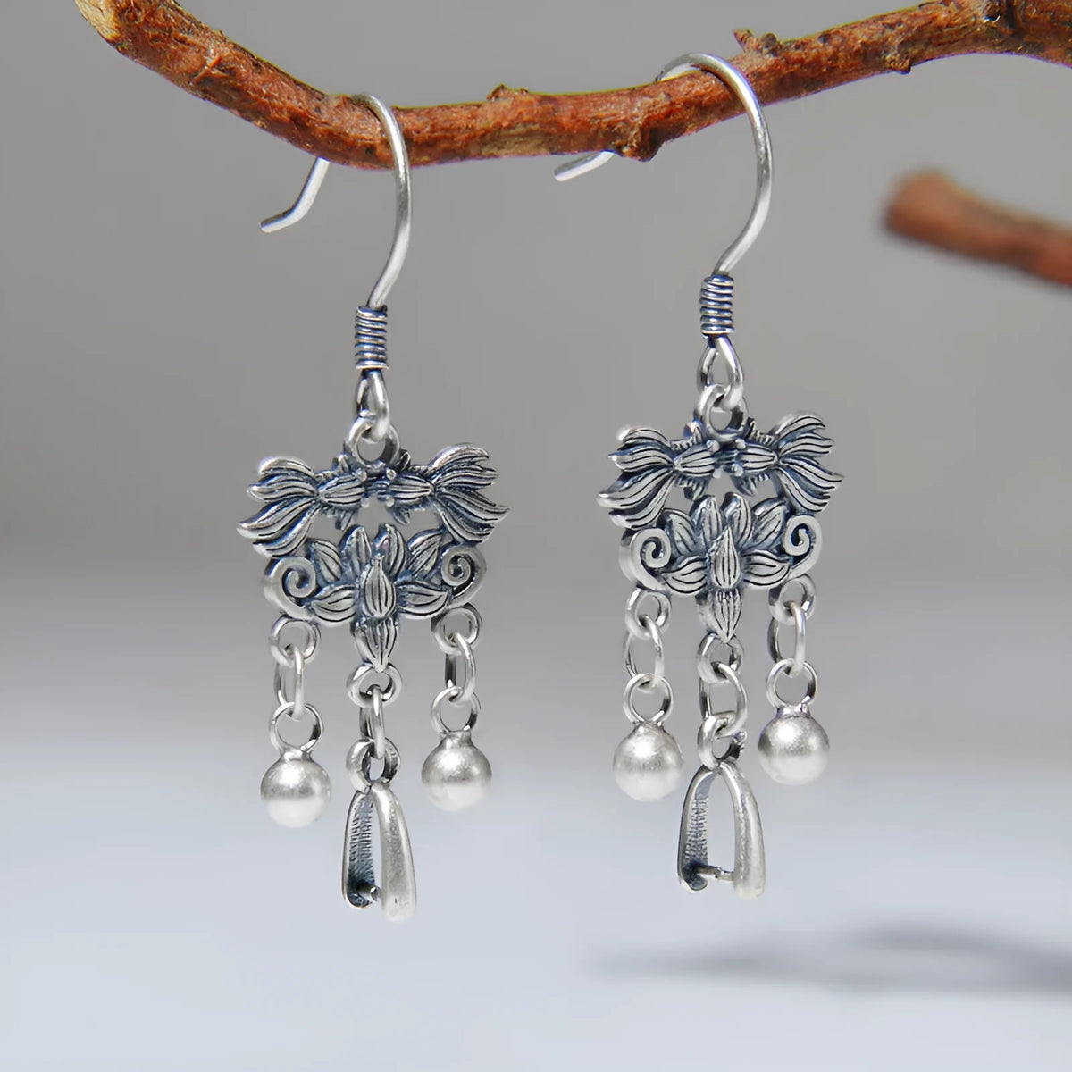 Pair of handmade 925 sterling silver koi earrings with silver colour and drop ear hook design