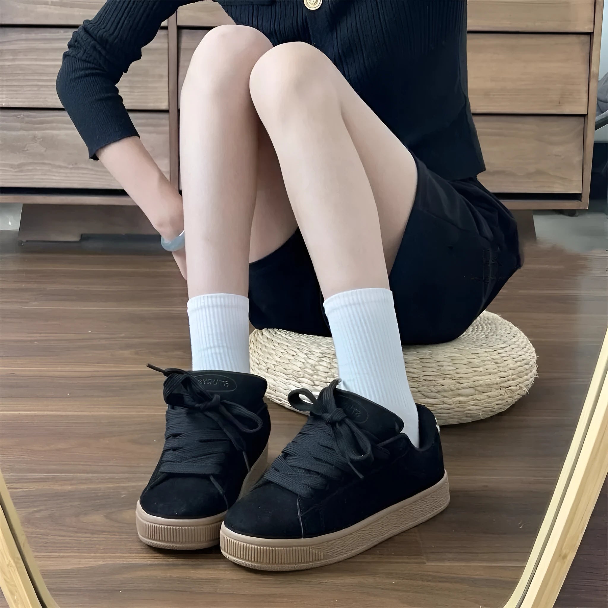 Retro black low-top sneakers on a waterproof platform sole with round toe and lace-up front.
