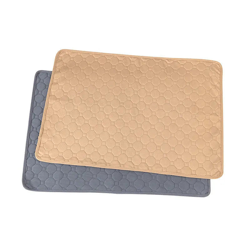 Tan and grey washable dog pee pad on a wooden floor, measuring 18 by 24 inches.