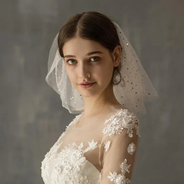 White yarn bridal multi-layer short veil with hair comb on a neutral background
