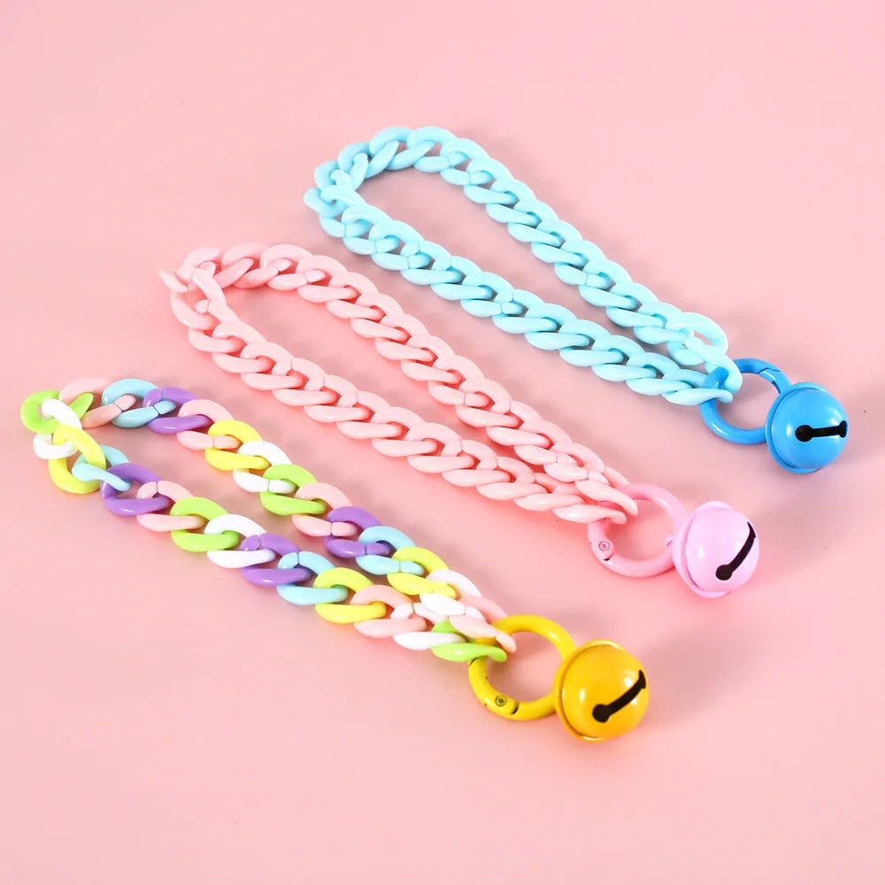 Adjustable plastic pet collar in macaron candy colours with chain detailing, shown with a buckle.
