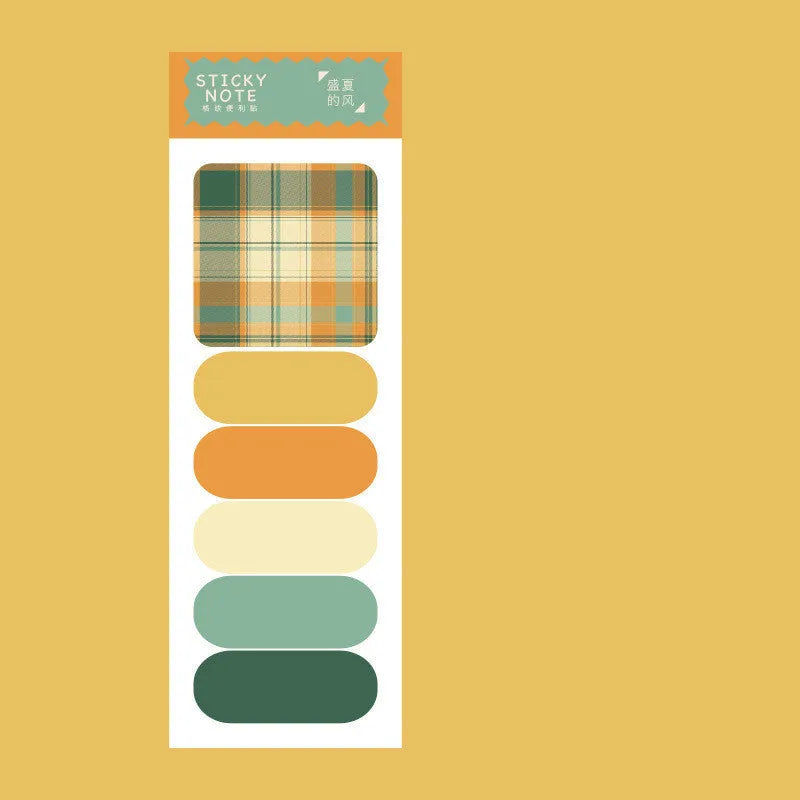 Colourful plaid sticky note memo pad showing eight different designs including blue, pink, and green patterns