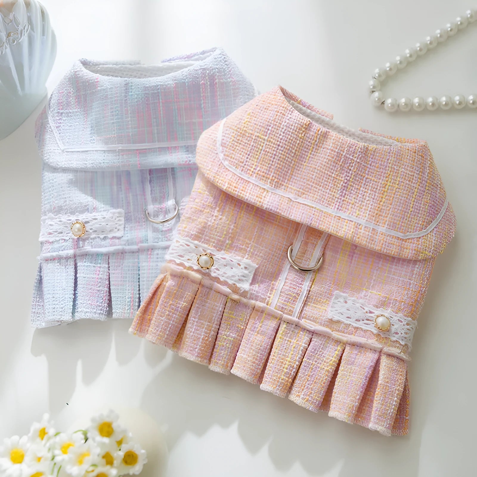A pink V-neck sweater for a small dog or cat, shown alongside a purple colour option.