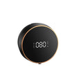 Black automatic sensor foam soap dispenser with USB port mounted on a white bathroom wall.