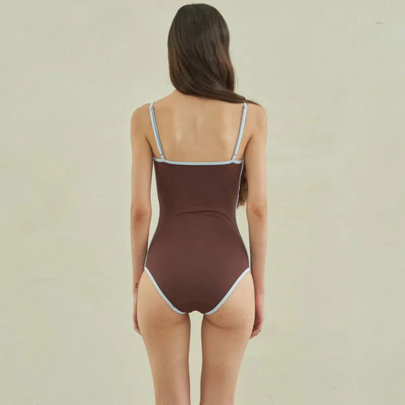 Brown women's one-piece triangle swimsuit made from nylon fabric on a mannequin.