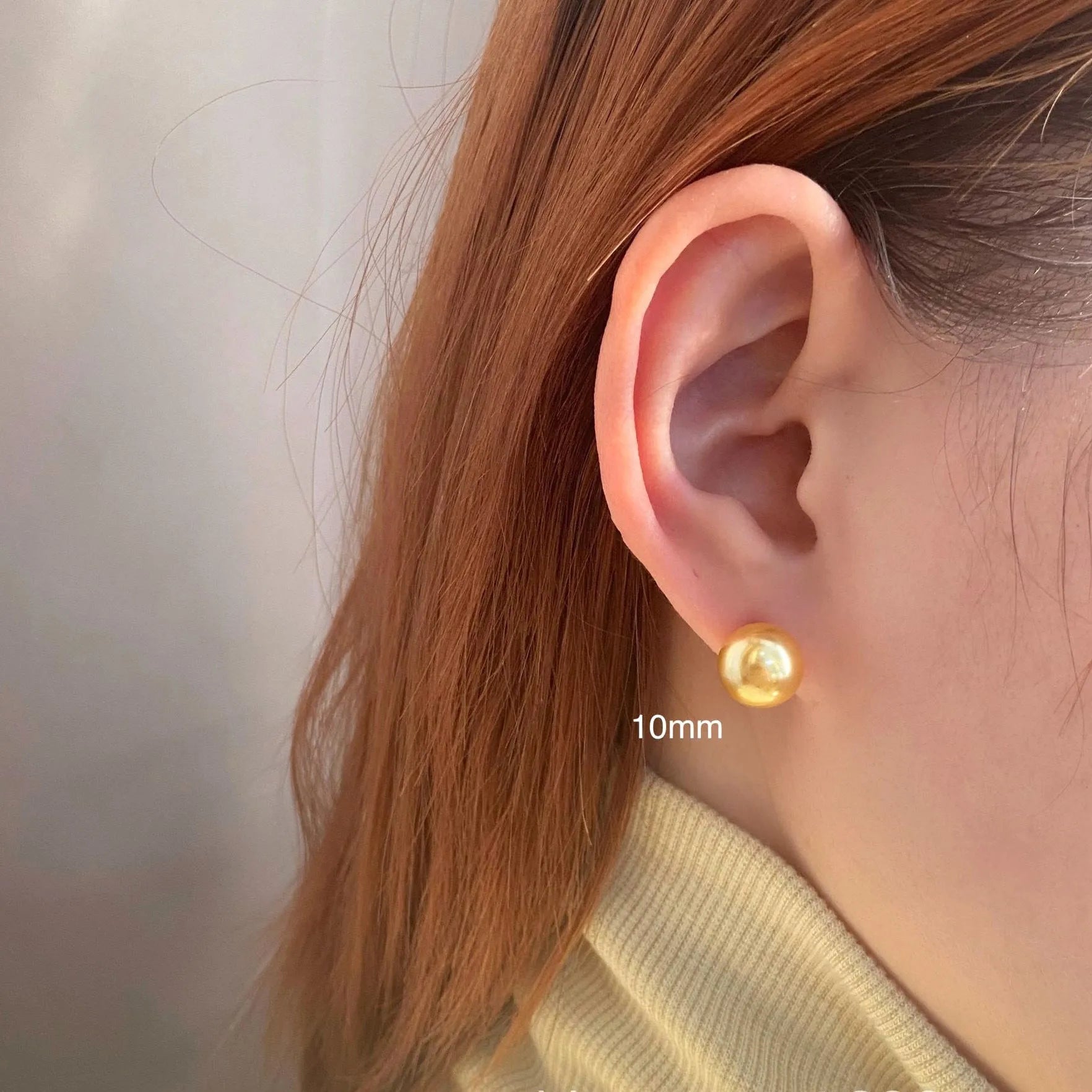 Large pearl stud earrings with a geometric star detail, shown in silver.