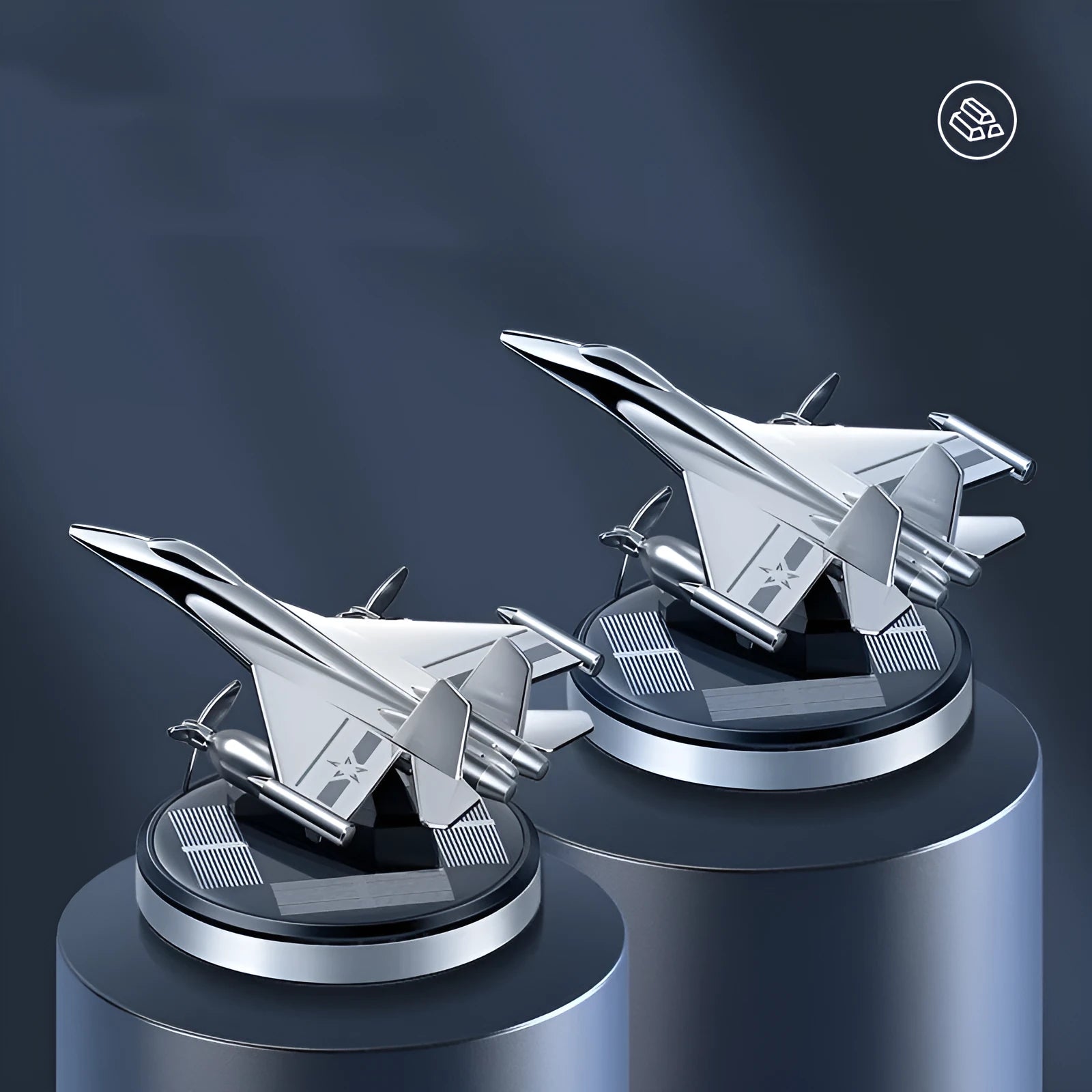 Solar-powered rotating fighter jet perfume ornament in silver, gold, blue, and red colours on a wooden surface.