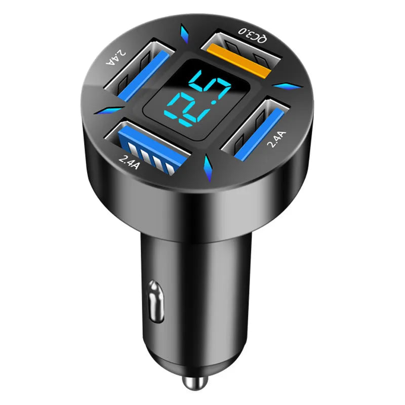 Black four-port USB car charger with LED voltage display plugged into a car socket.
