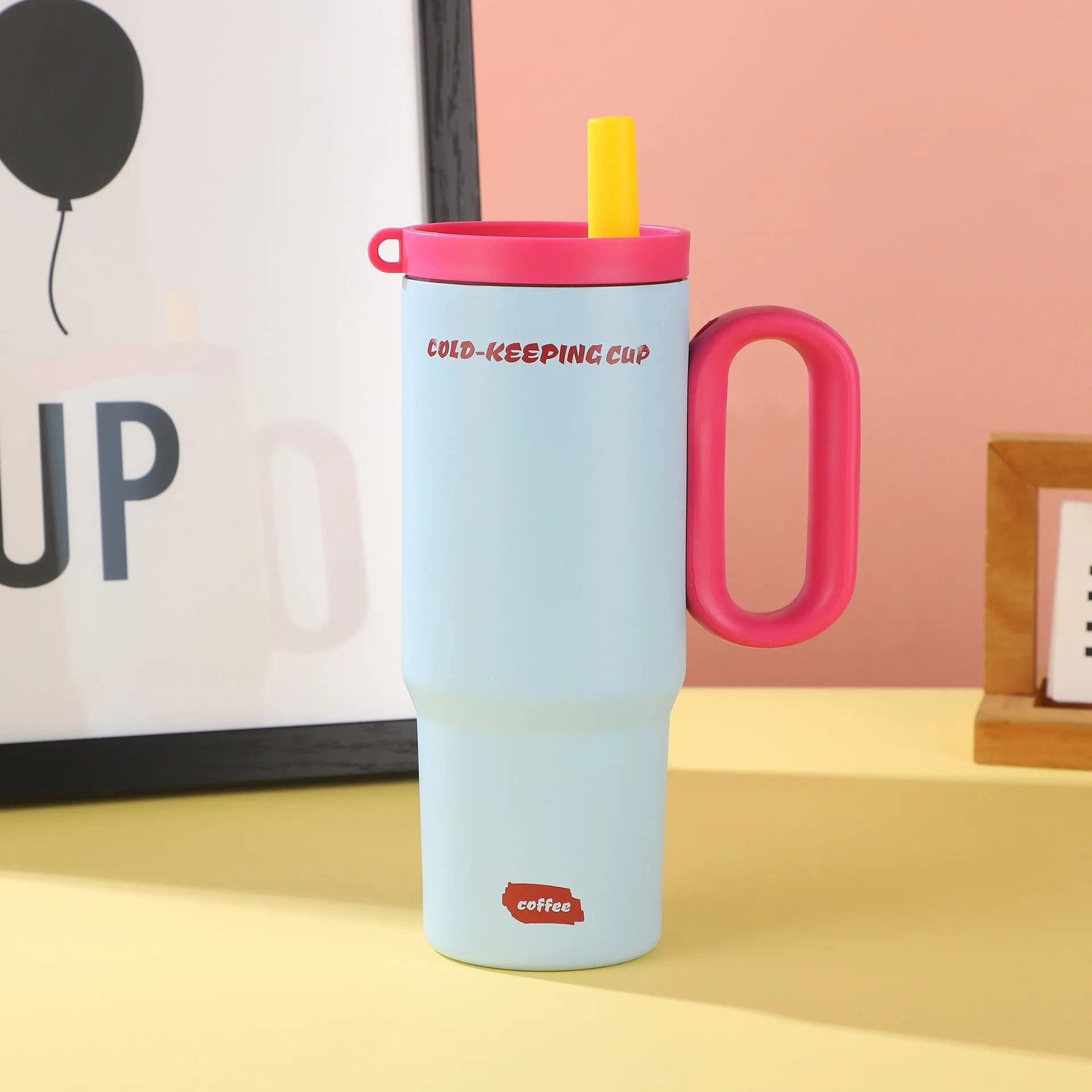A large insulated portable cup with a handle, shown in multiple colour options.
