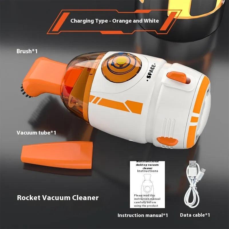 Handheld USB desktop vacuum cleaner in blue rocket design on a wooden desk next to a keyboard