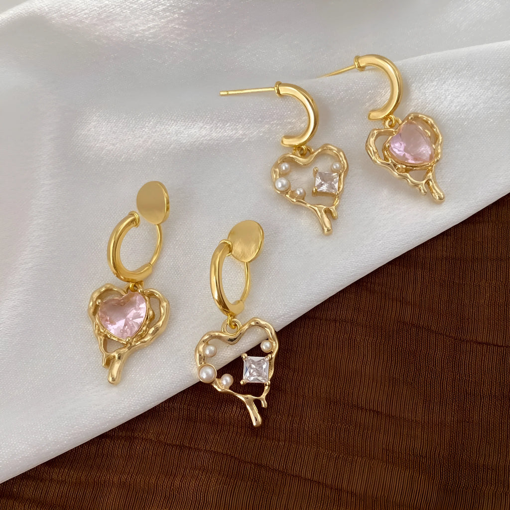 Asymmetric heart earrings with inlaid zircon on copper, available as ear clips or ear studs, one pair