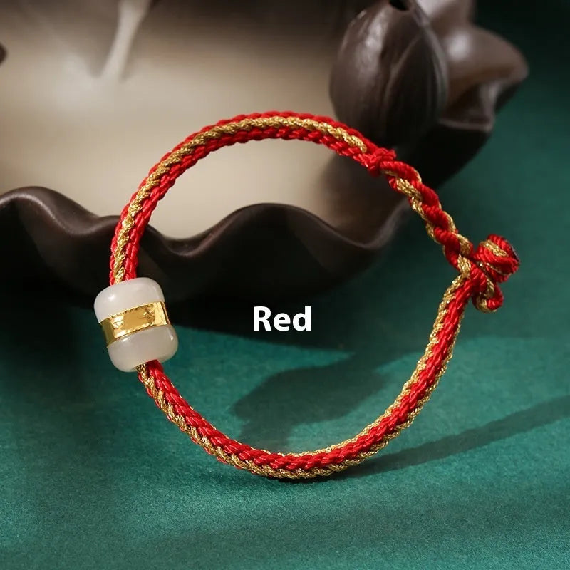 Hand-woven bracelet with Hetian jade inlay gold tone finish geometric shape on dark background