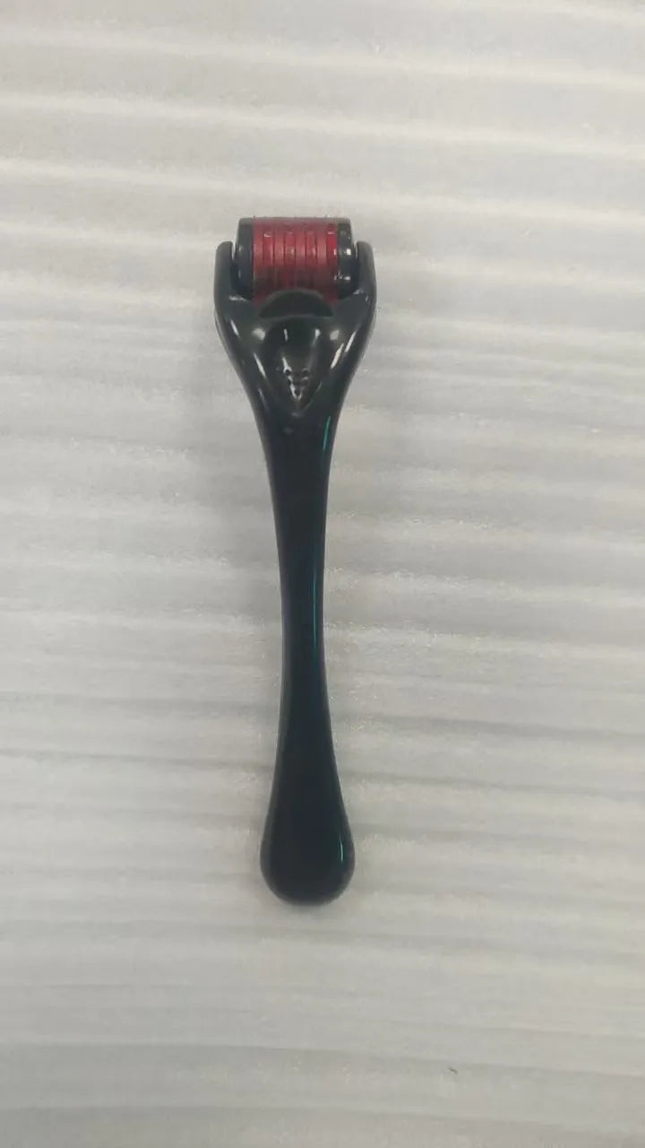 540 micro needle roller tool with black handle and coloured wheel on a white background.