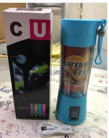 Mini USB-powered centrifugal fruit juicer in pink, with a 400ml plastic cup and stainless steel blade.