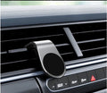 Black car bracket with rotatable ball joint plugged into a vehicle 12V socket