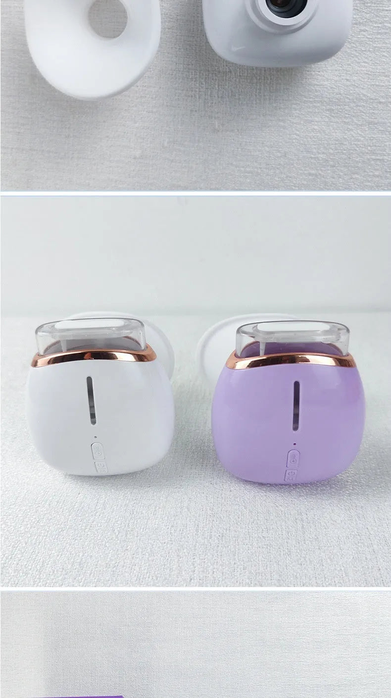 White and purple household eye humidifier with charging cable on wooden table