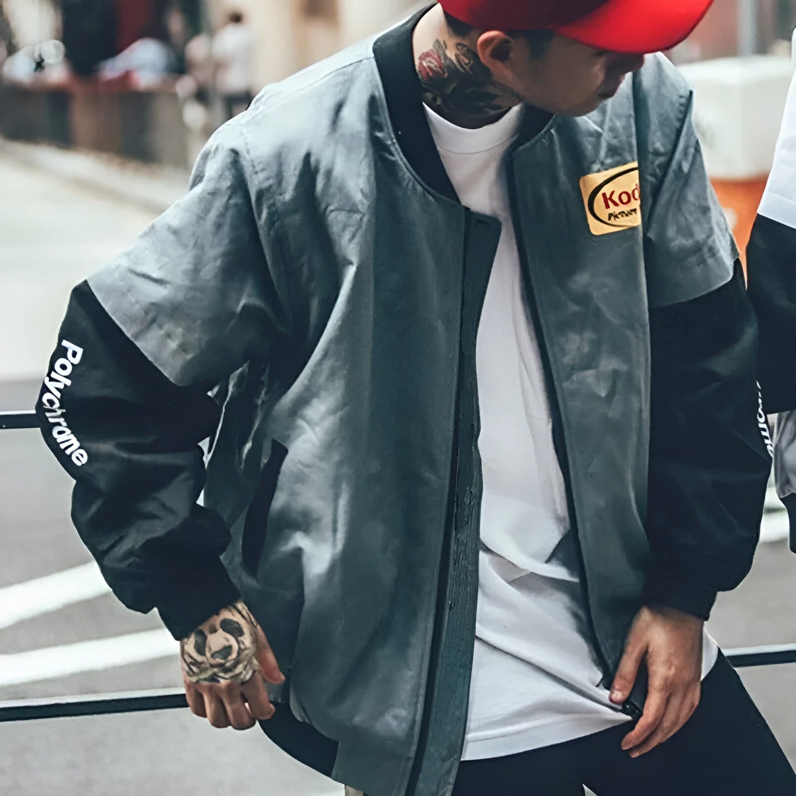 Hip hop style printed baseball jacket in Grey with round neck and side slit pockets on a model
