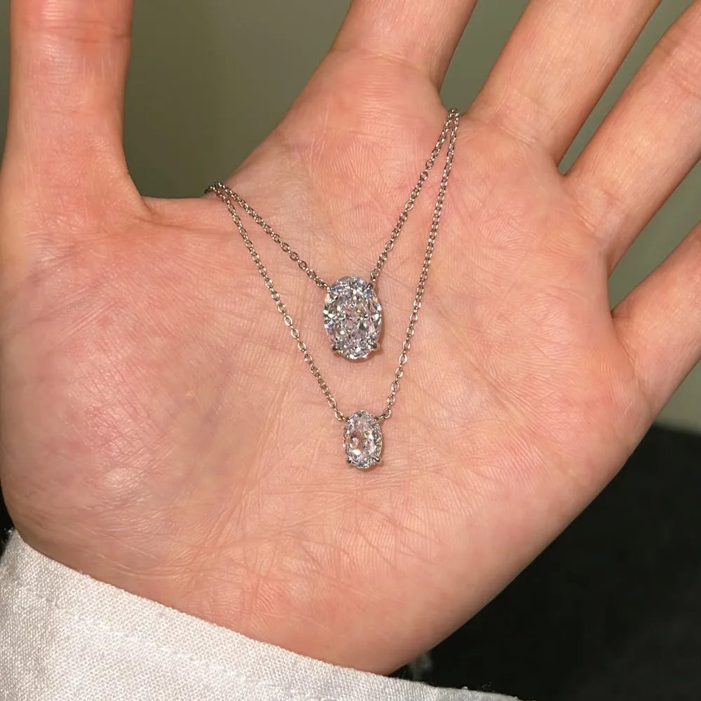 Close-up of a women's sterling silver necklace with a geometric oval ice flower pendant.