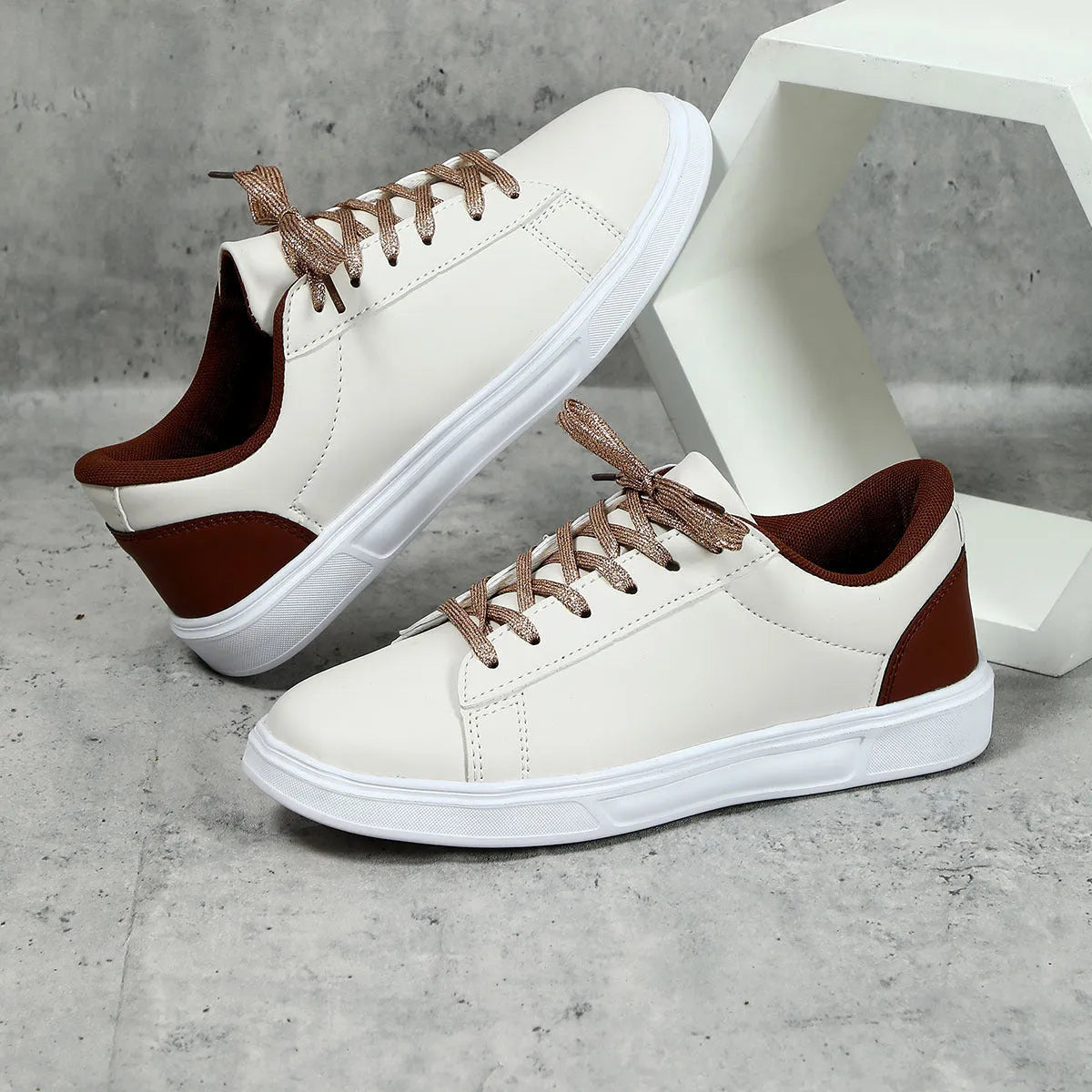 Platform skateboard casual sneaker in beige brown with low top, round toe, and a cross strap detail.