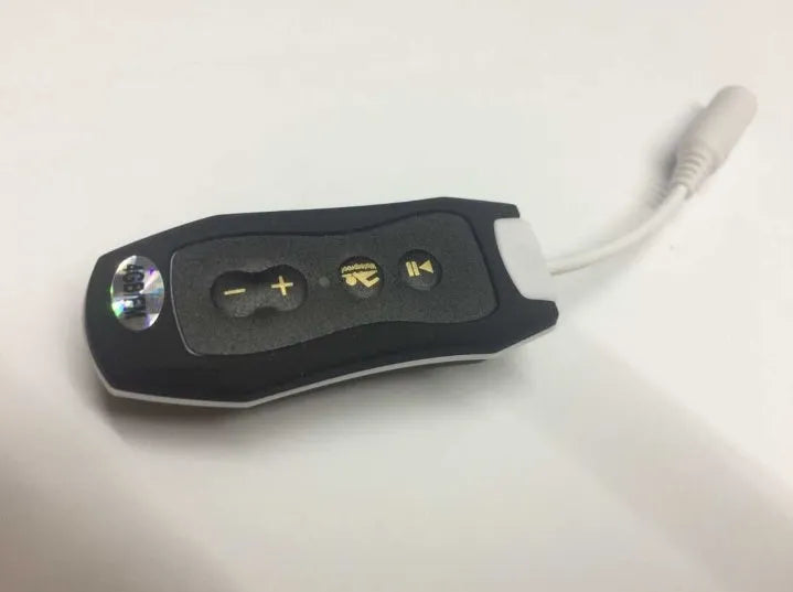 Compact black waterproof MP3 player earphone with USB cable, shown next to a ruler for scale.