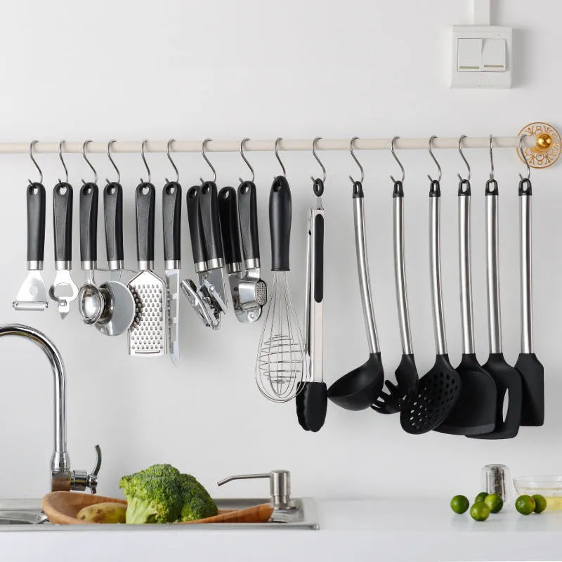 Black kitchen spatula and spoon set with stainless steel handles and silicone heads