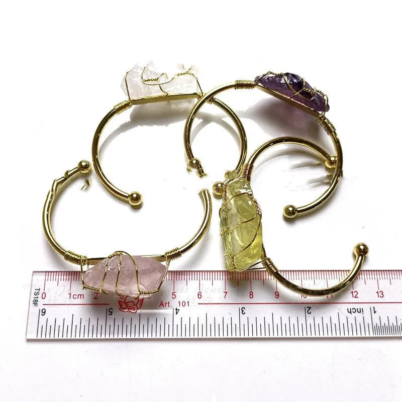 Unisex geometric bracelet made from rough natural crystals with gold metal winding.