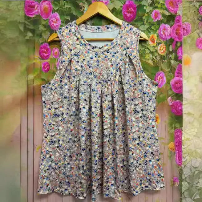Black plus size sleeveless vest with floral print, showing loose fit and round neckline on a hanger.