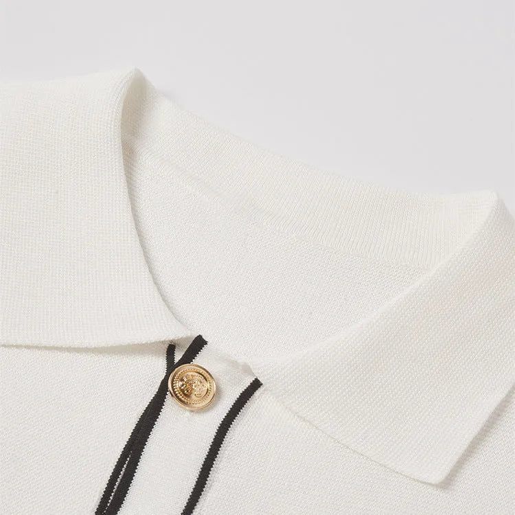 White short sleeve cardigan with dark contrast colour lapels, laid flat to show relaxed fit and button front.