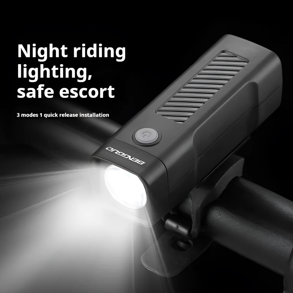 A black USB rechargeable bicycle headlight mounted on handlebars with a quick-release strap.
