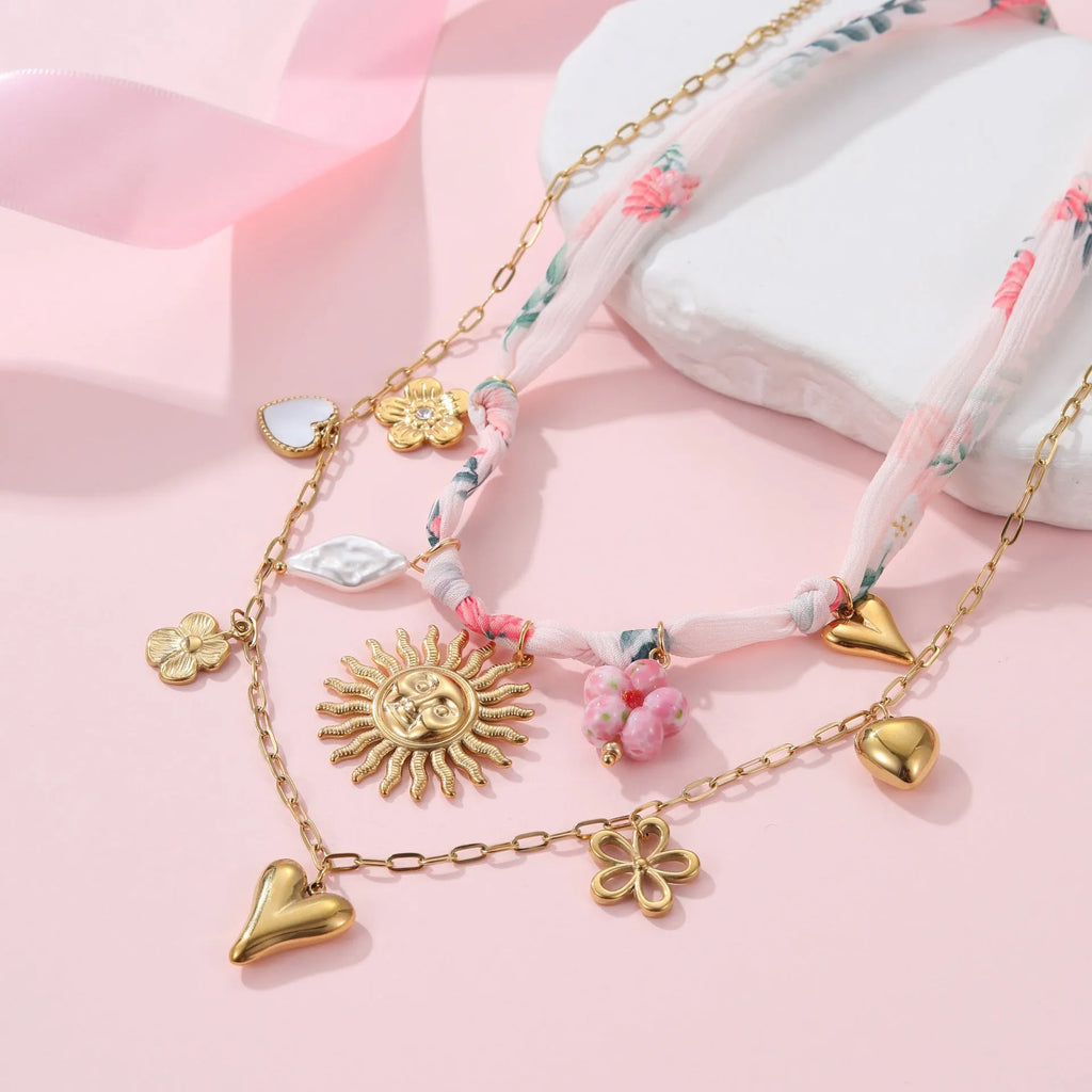 Stainless steel necklace with geometric sun pendant and 18K gold electroplated finish