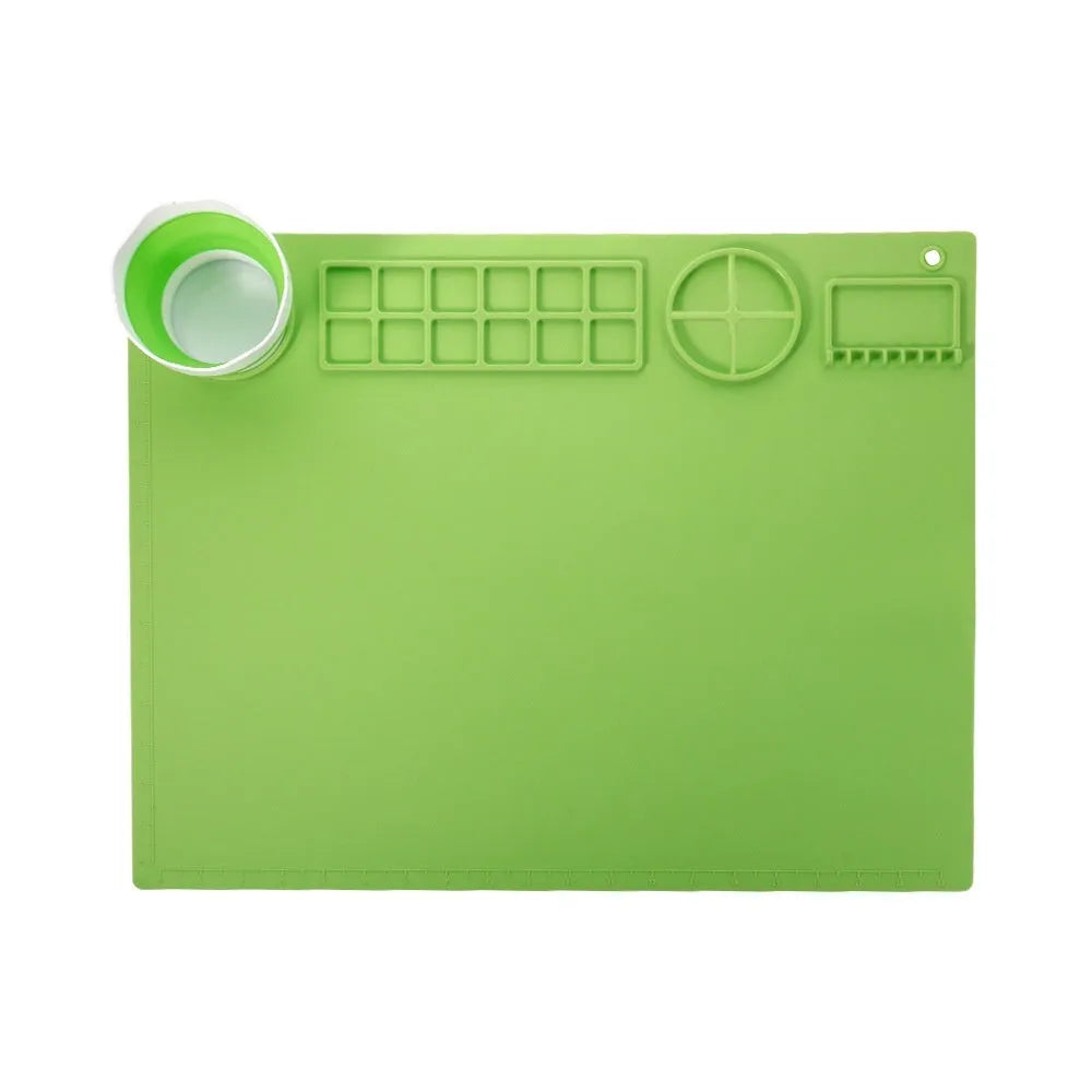 Green silicone painting mat measuring 50 by 40 cm, shown with two integrated bowls for paint or water.