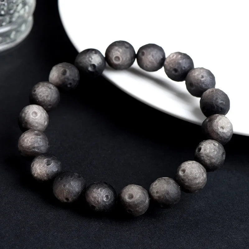 Natural obsidian crater ball bracelet with meteorite texture in silver stone and gold obsidian colour variations