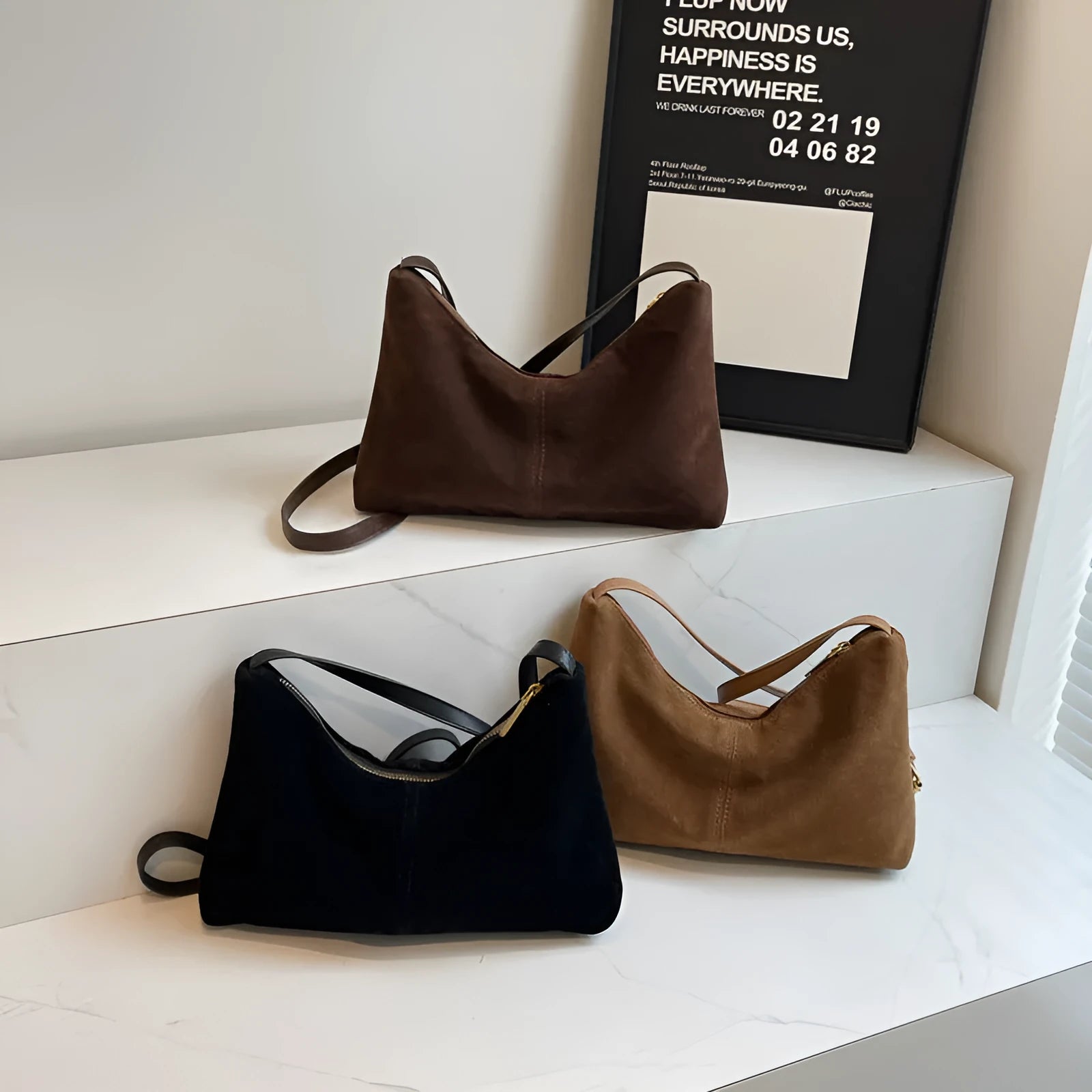 Retro brown suede underarm bucket bag with visible sewing line detail on a woman's shoulder during commute