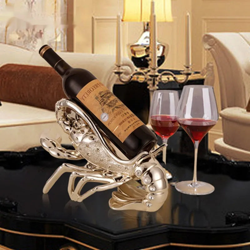 Lobster-shaped decorative wine rack ornament in rose gold or silver finish on a tabletop.