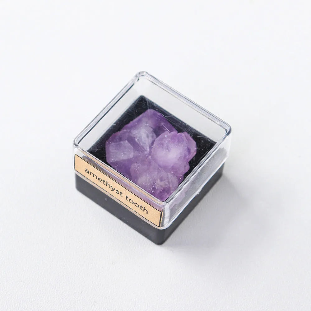 Geometric natural amethyst crystal ore mineral specimen decoration on a wooden surface.