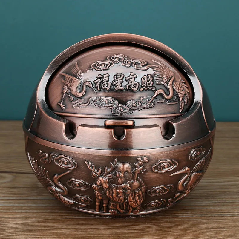 Bronze alloy ashtray with decorative fortune tree design and smoke extinguishing slot.