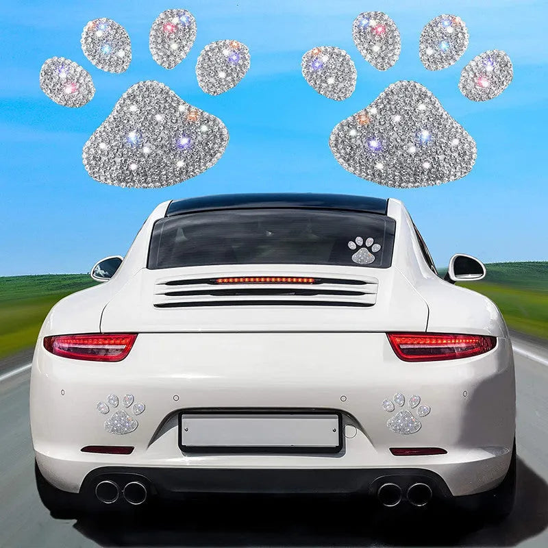 Close-up of a white diamond glass car sticker with a butterfly and bear paw design.