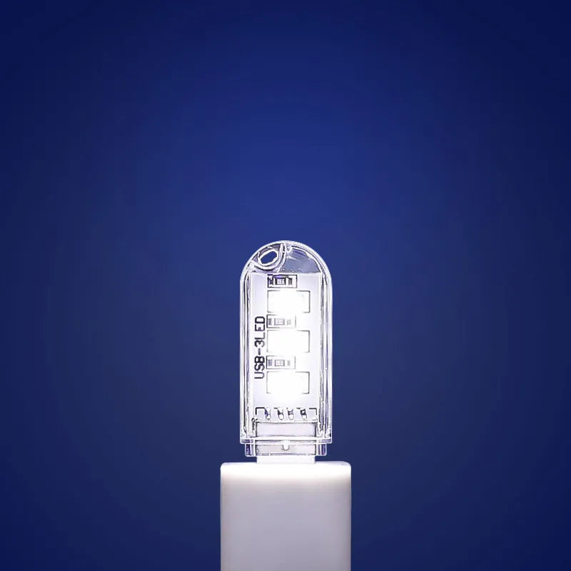 Small white USB-powered LED night light showing warm and white light options