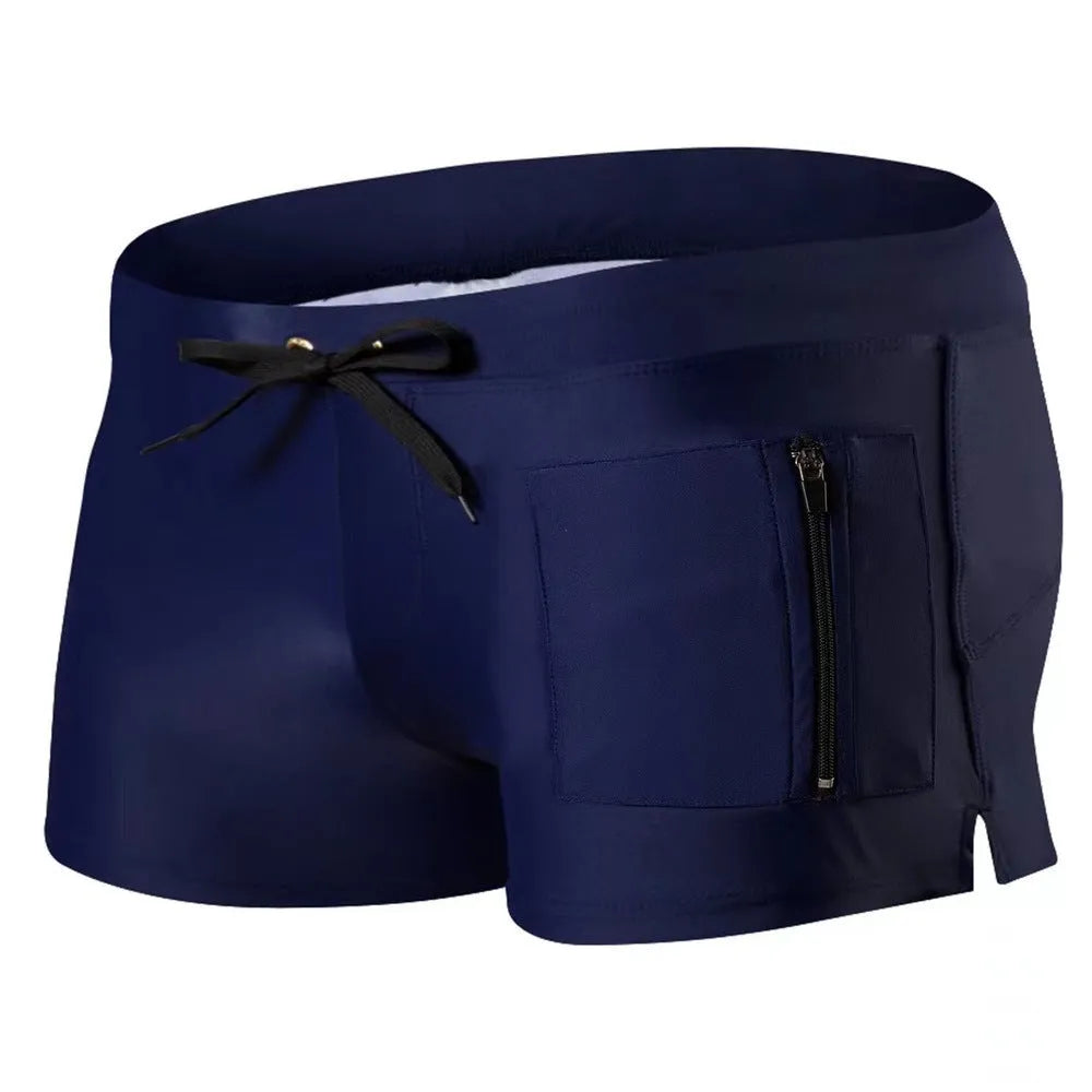 Men's solid colour polyester swimming trunks with high waist and lace-up brief design.